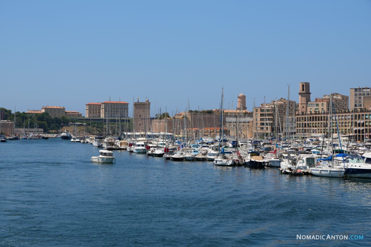 Rows of sailboats in Vieux Port with Marseille’s waterfront behind them.
