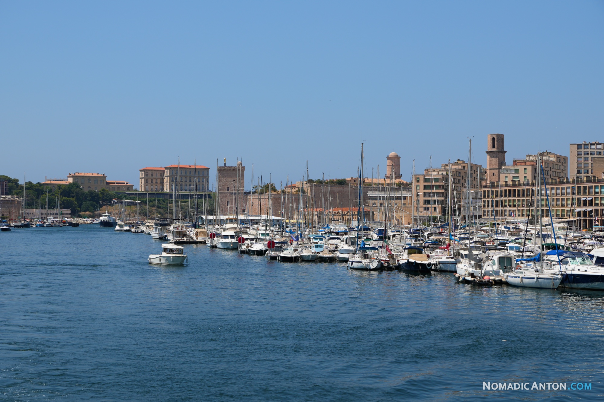Rows of sailboats in Vieux Port with Marseille’s waterfront behind them.