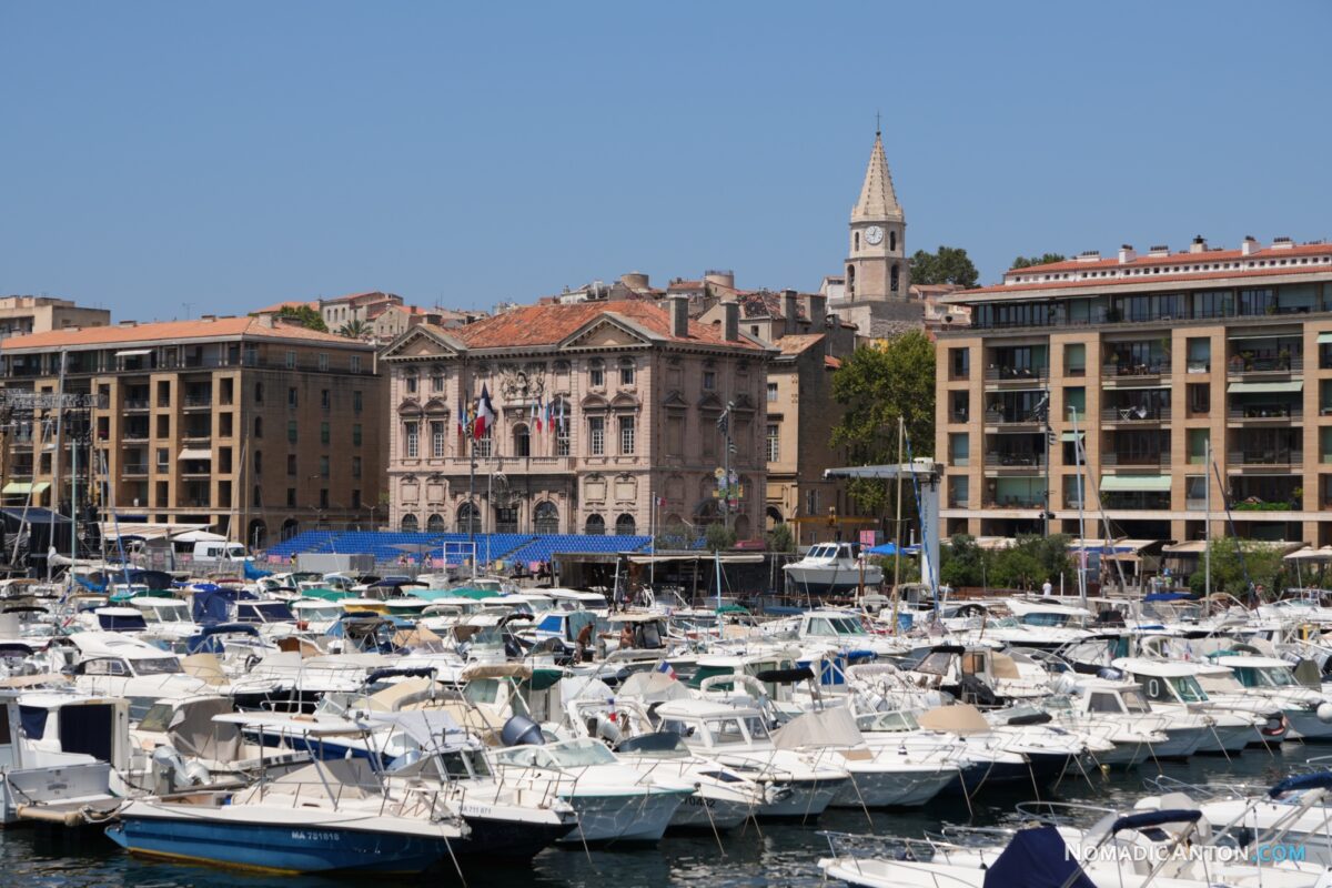 Closely moored motorboats with stone waterfront buildings behind them.