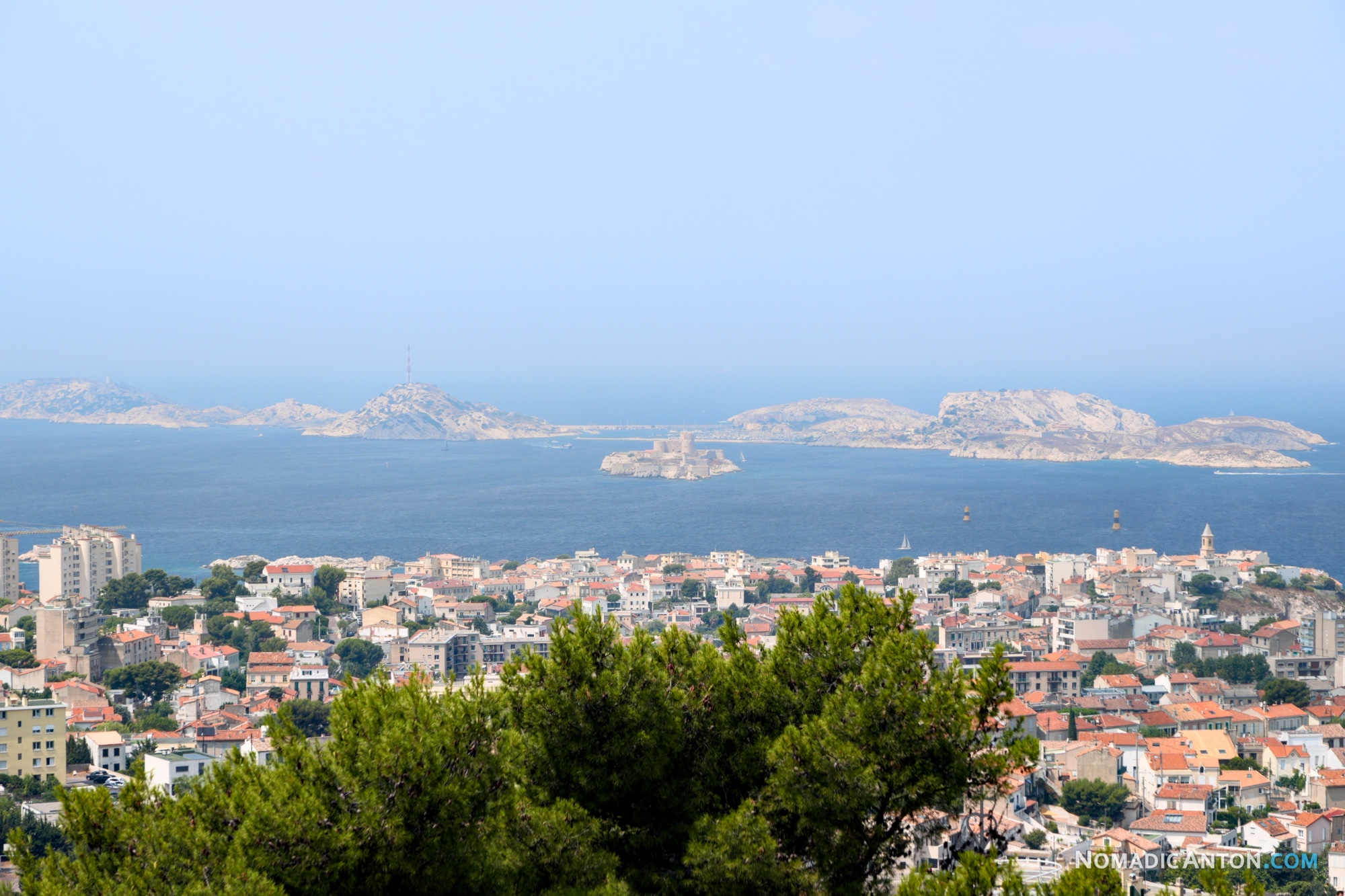 Marseille rooftops stretching toward the sea and the Frioul Islands offshore.