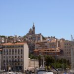 Boat masts and Marseille rooftops below Notre-Dame de la Garde.