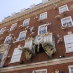 Fortnum & Mason's ornate clock and gold bee sculptures on its Piccadilly facade