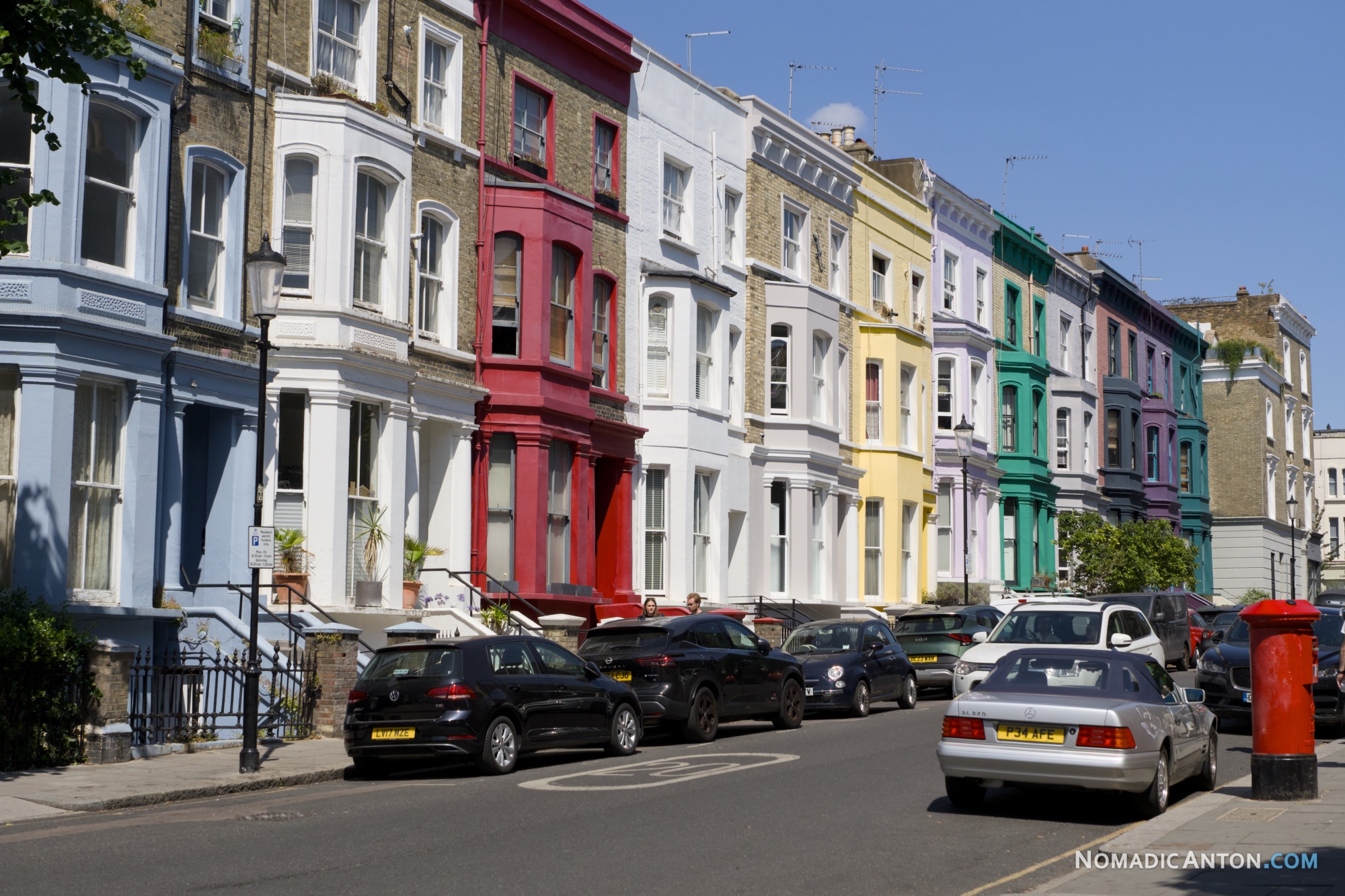 Row of brightly colored townhouses on a residential street in Notting Hill