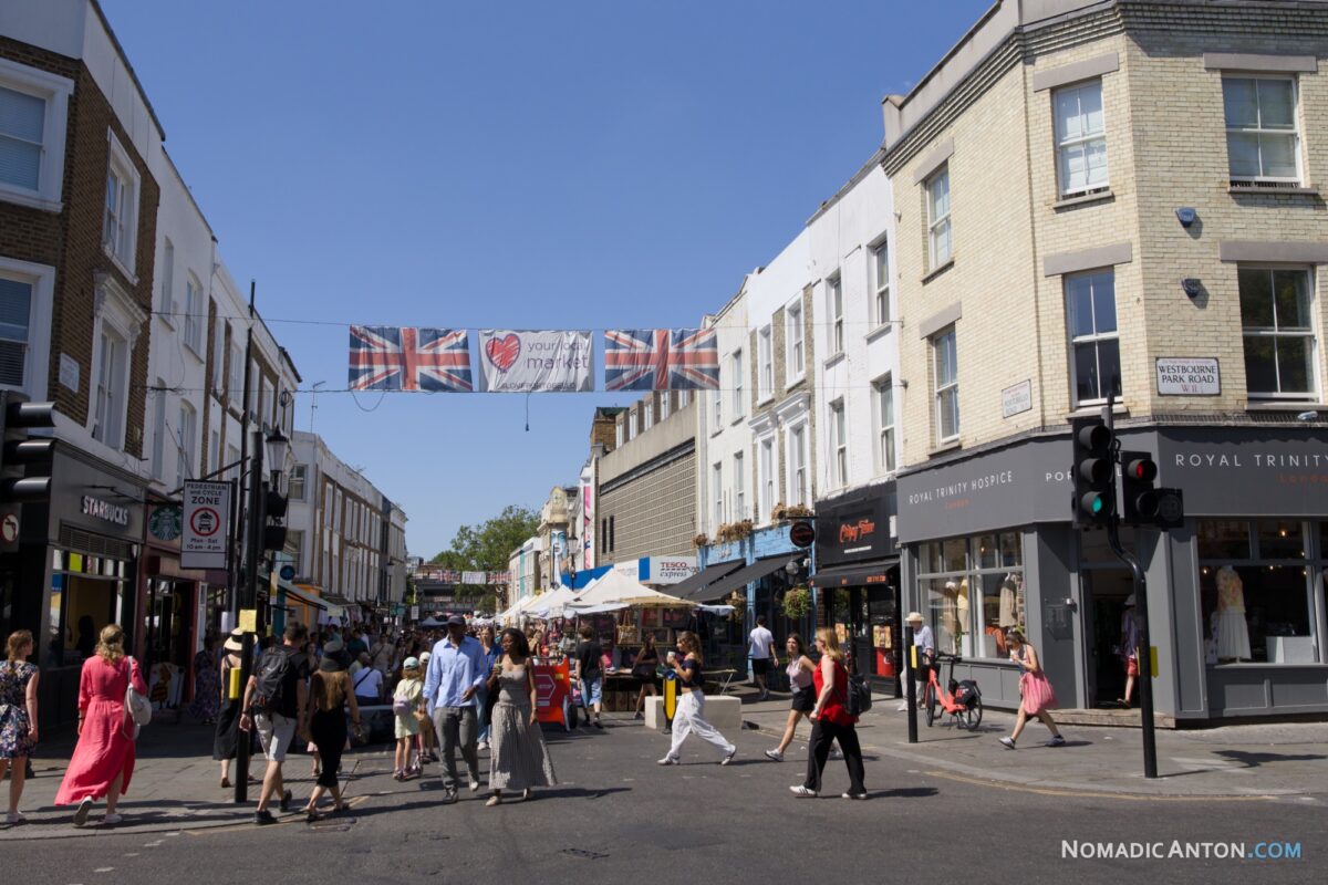 Crowds walking through Portobello Road Market in Notting Hill, London