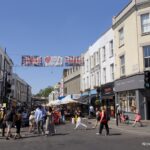 Crowds walking through Portobello Road Market in Notting Hill, London