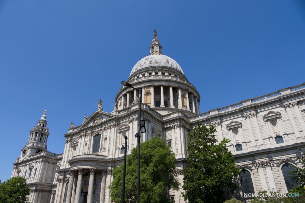 St Paul's Cathedral dome viewed from street level against a blue sky