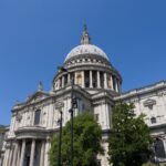 St Paul's Cathedral dome viewed from street level against a blue sky