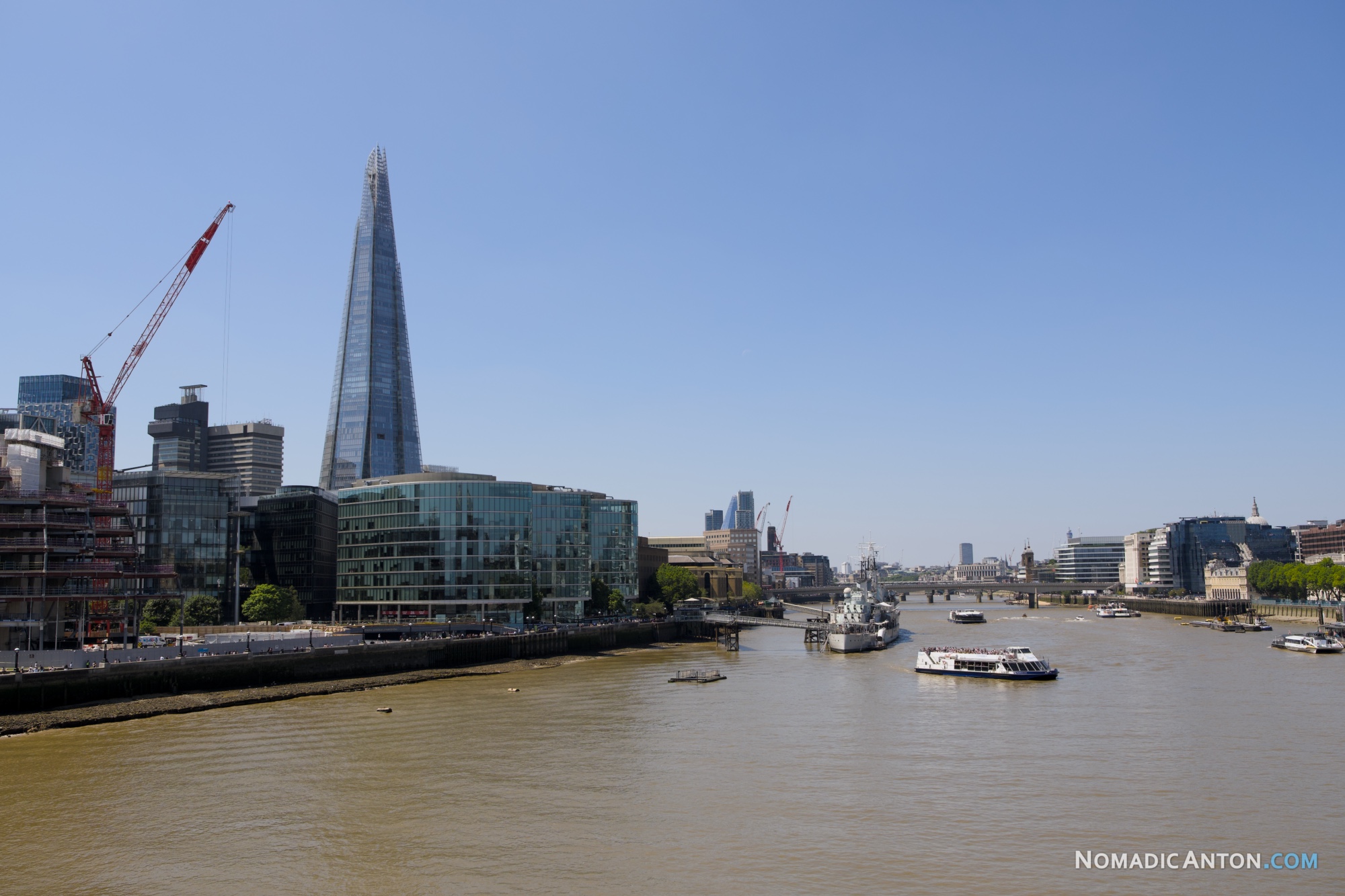 The Shard skyscraper viewed from Tower Bridge, next to HMS Belfast on the River Thames