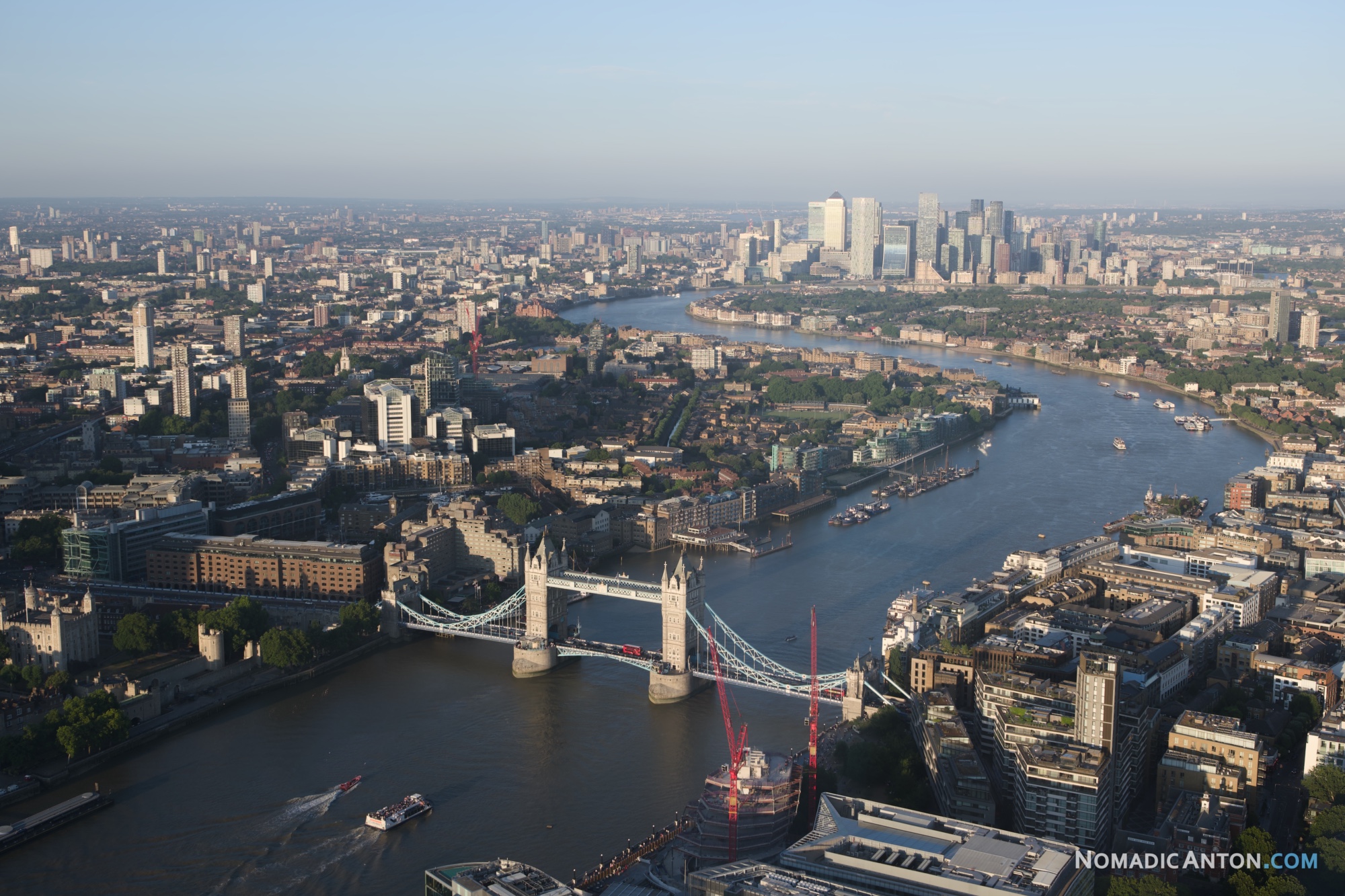 Aerial view of Tower Bridge and the River Thames with Canary Wharf in the distance