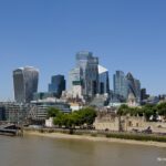 Skyscrapers of the City of London rising behind the Tower of London and the River Thames